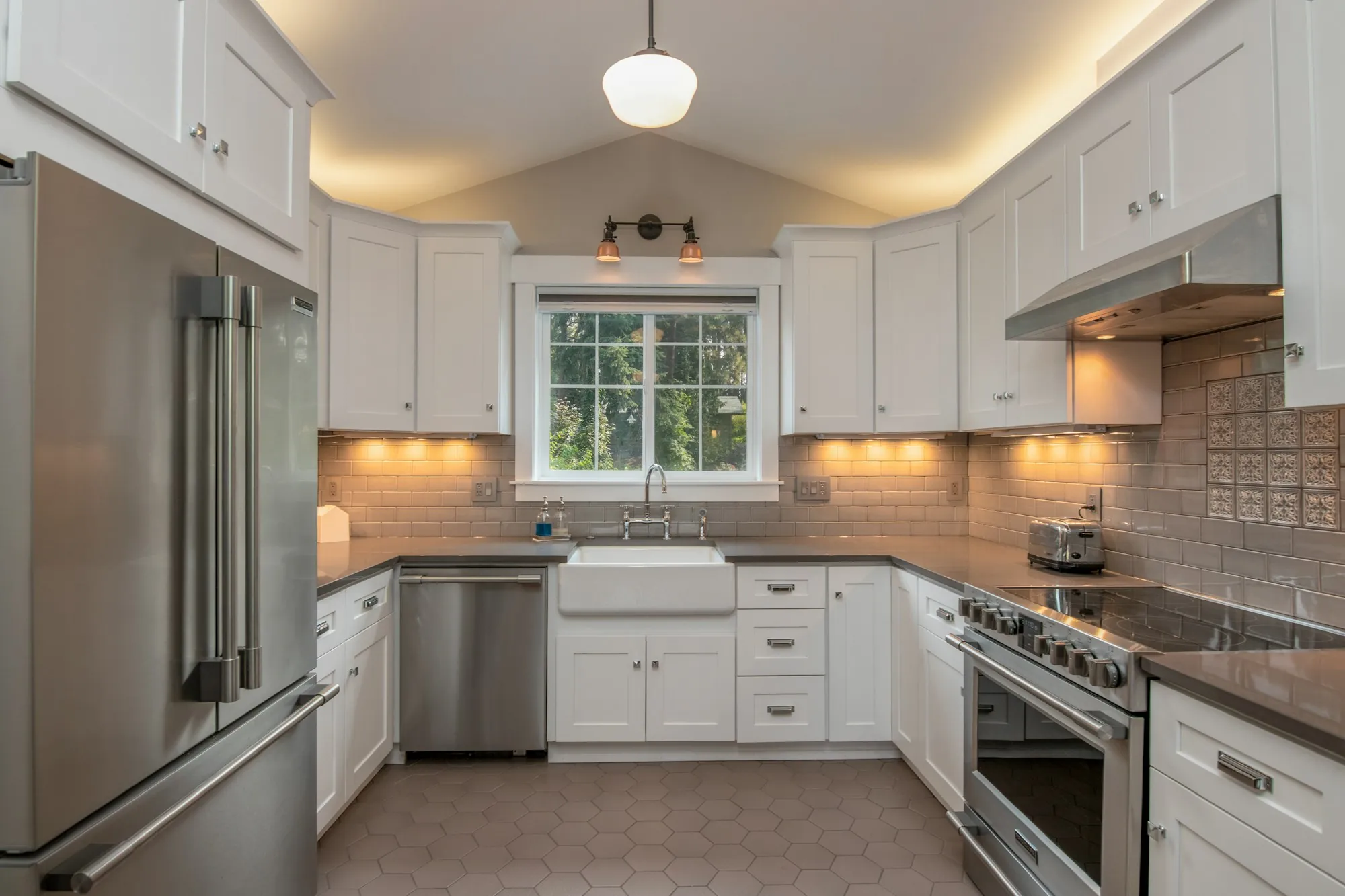 Renovated kitchen with white cabinets and under-cabinet lights