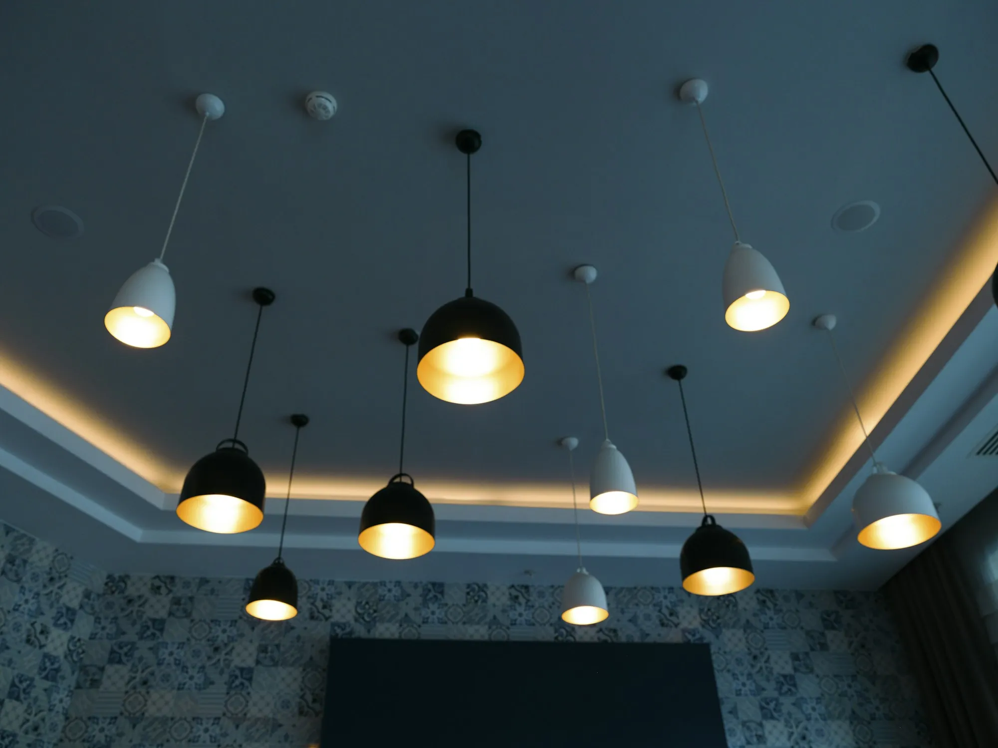 Pendant lights hanging from a lit ceiling